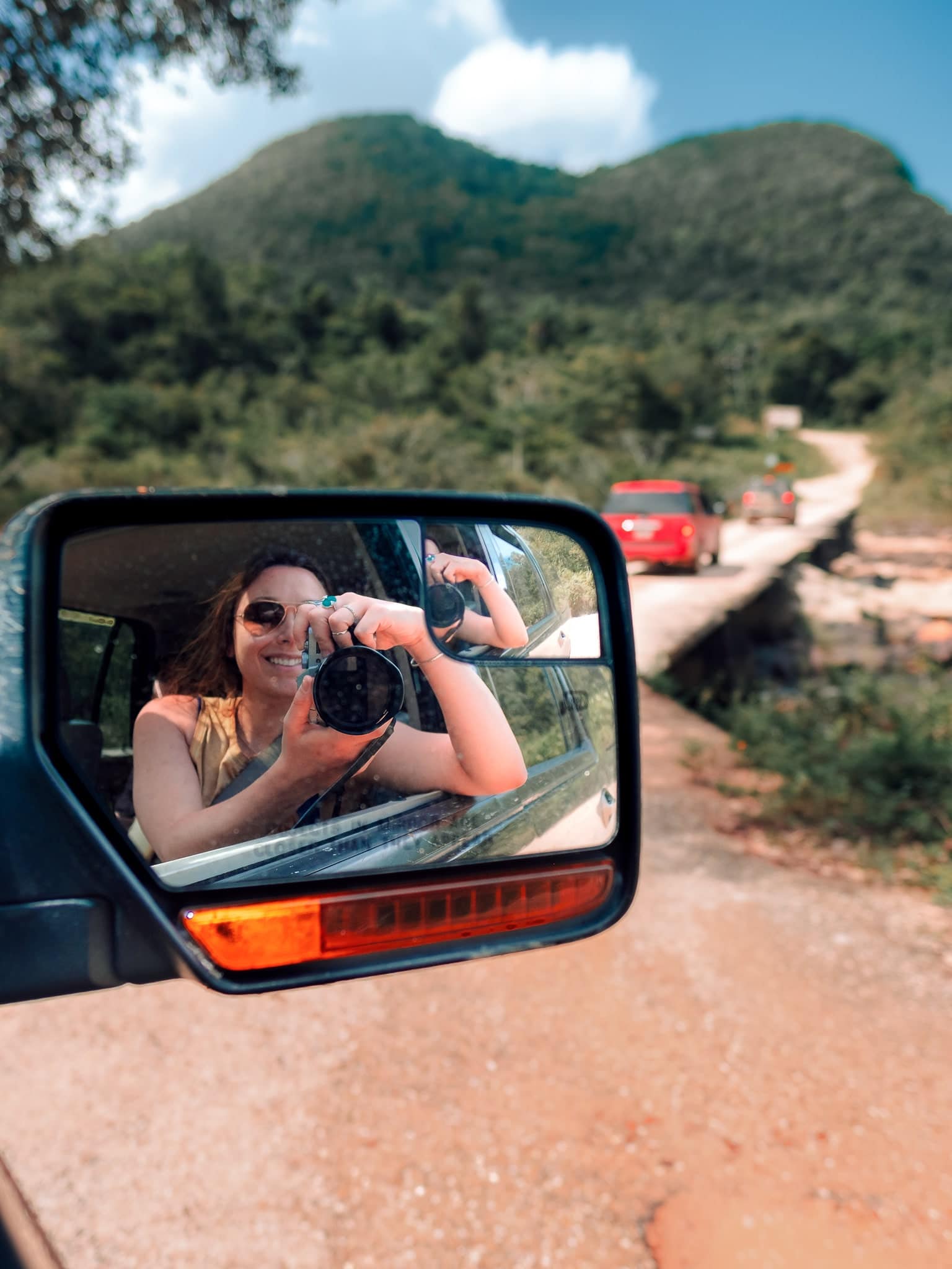 Mirror selfie in a rental car on a road trip through Belize