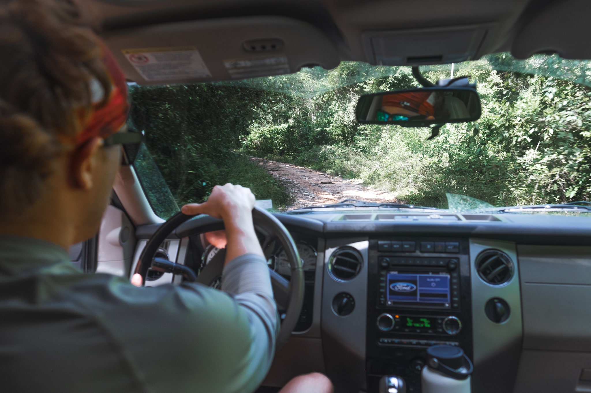 Driving a rental car down a jungle road in Belize