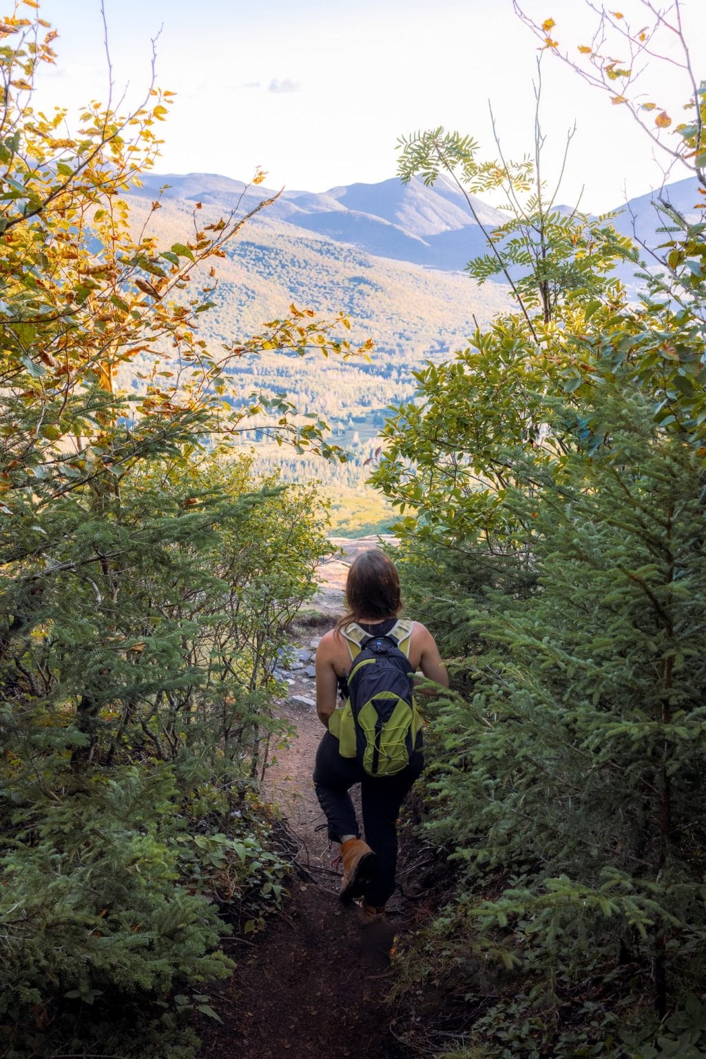 Girl with a backpack, hiking on a trail in Upstate New York