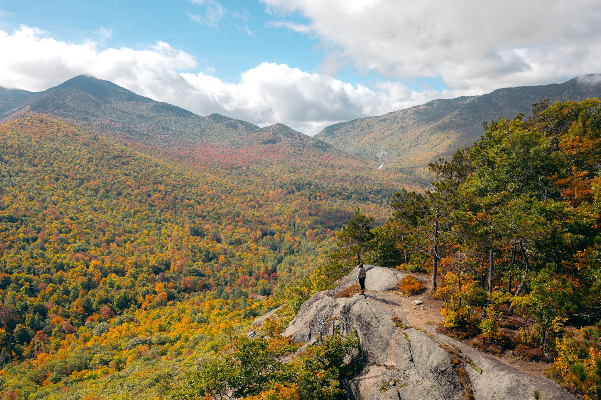 A hiker in the Adirondack Mountains, prepared with everything you should pack for a day hike