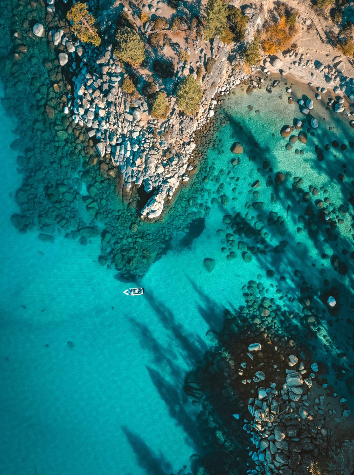A kayaker paddling on Lake Tahoe's blue water in the summer