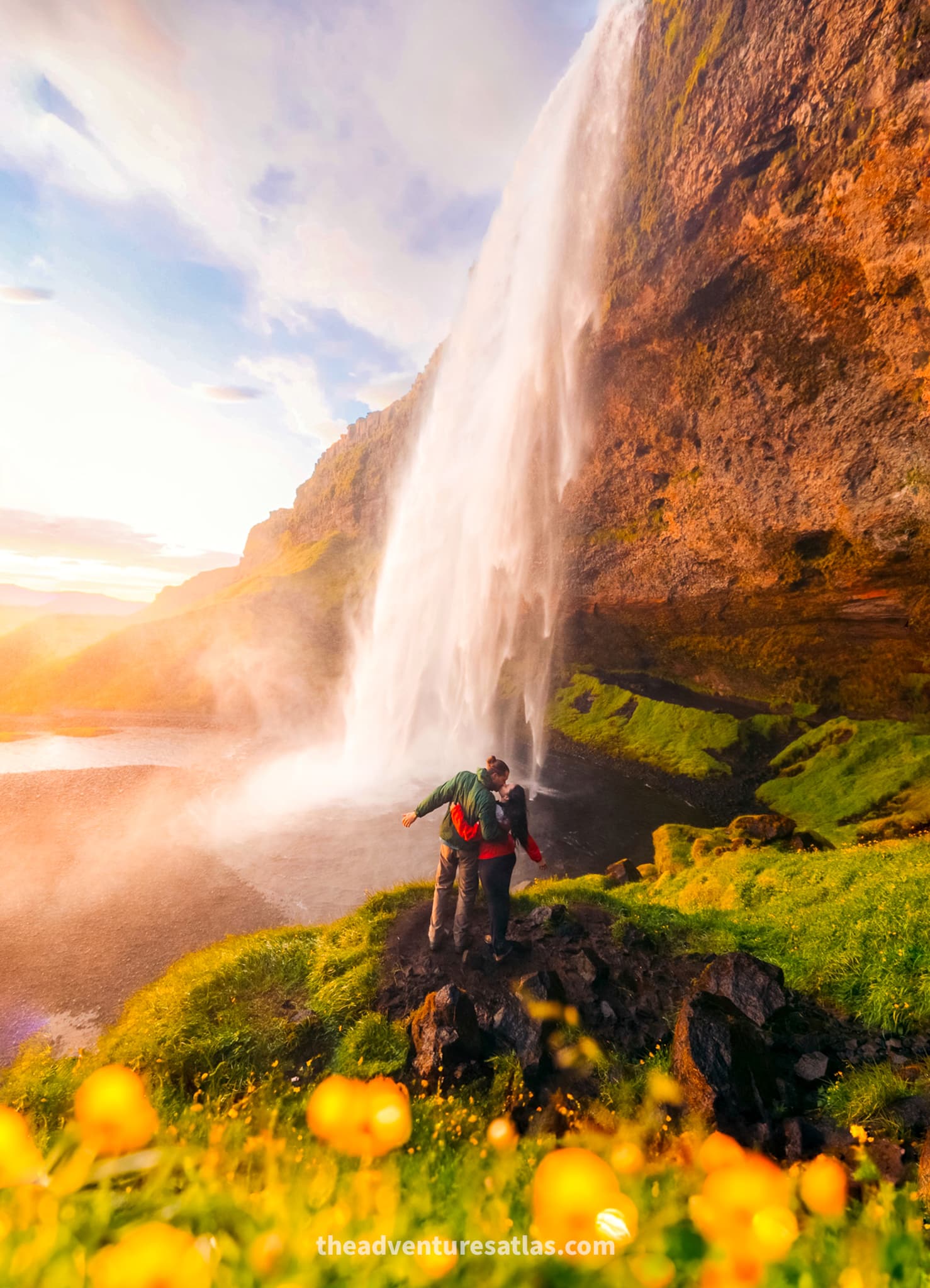 Couple dressed in rain jackets and rain pants at Seljalandsfoss