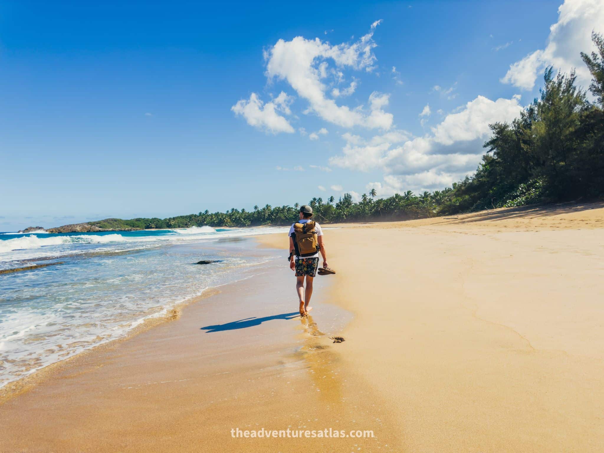 Man walking on a hidden, secluded beach on the north shore of Puerto Rico